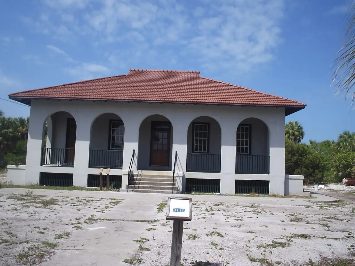 Historic guardhouse with arched windows and a red tile roof