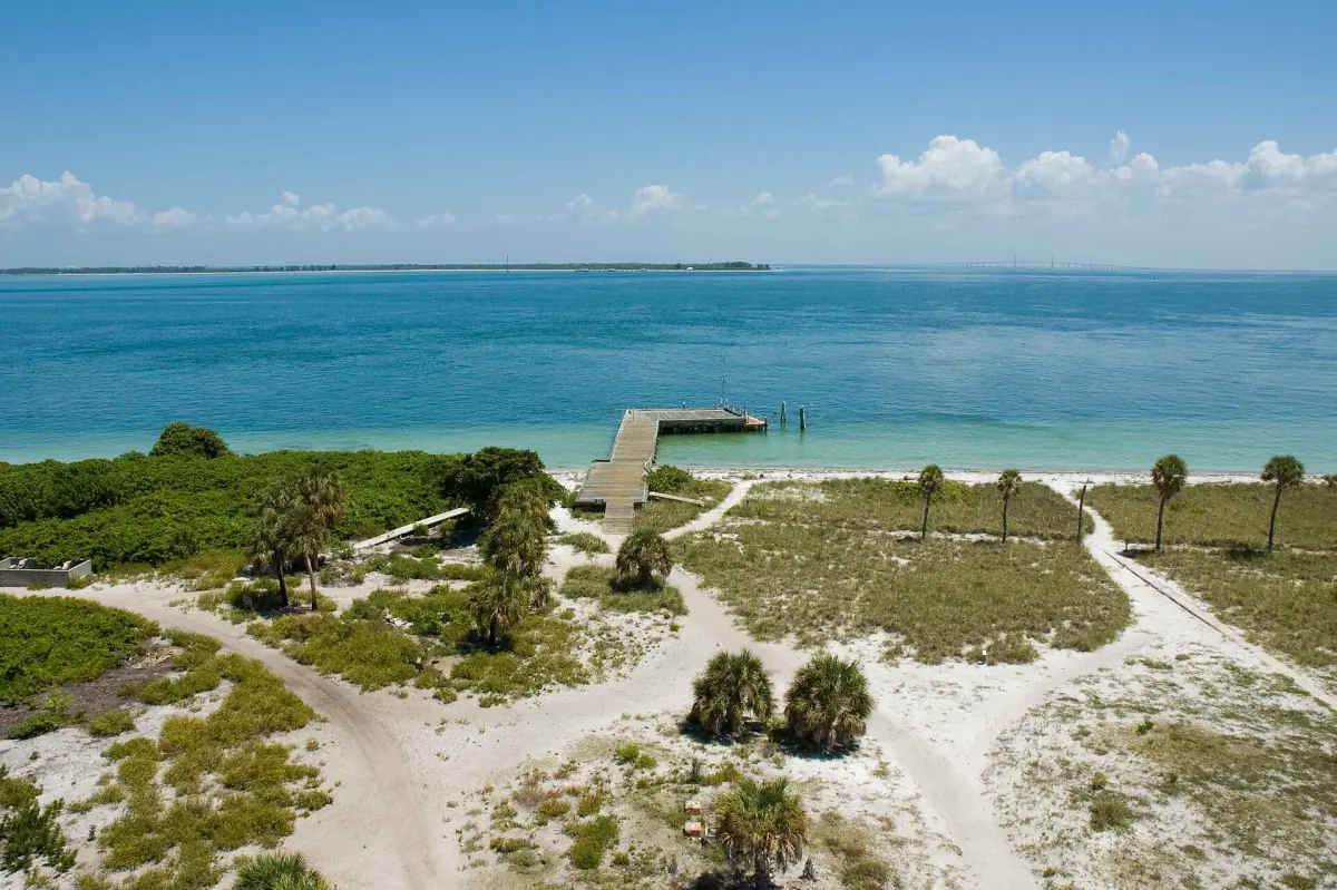 View from the lighthouse over beach, trees and turquoise sea